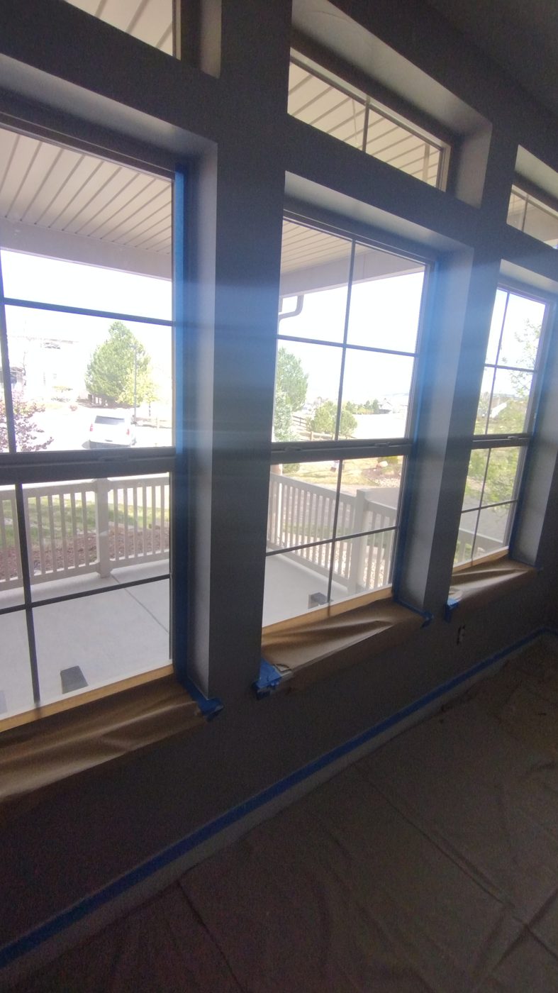 Window trim taped and sills masked before painting by Rock's Finest Finishes